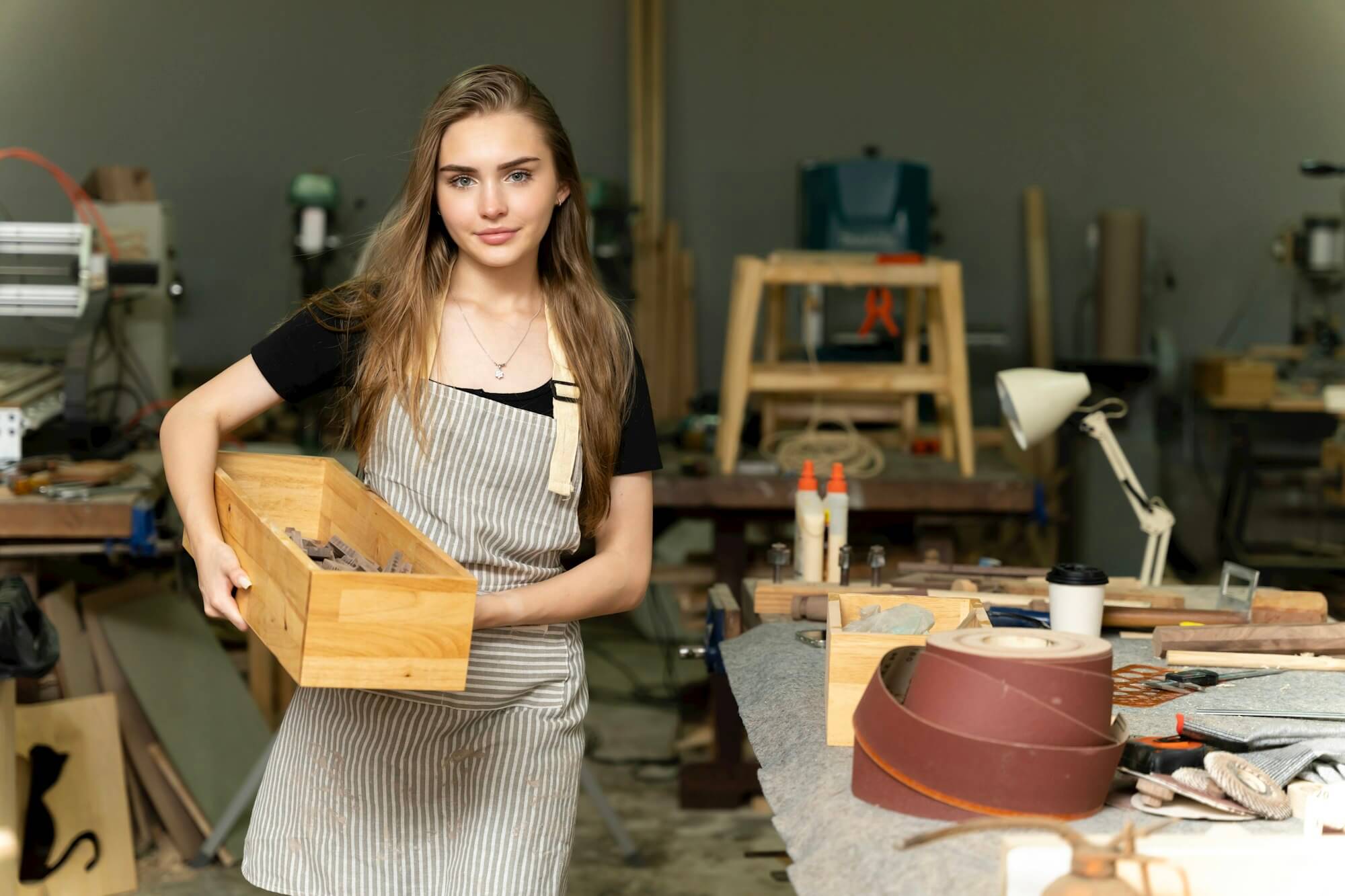 a-female-carpenter-is-working-at-a-furniture-factory.jpg